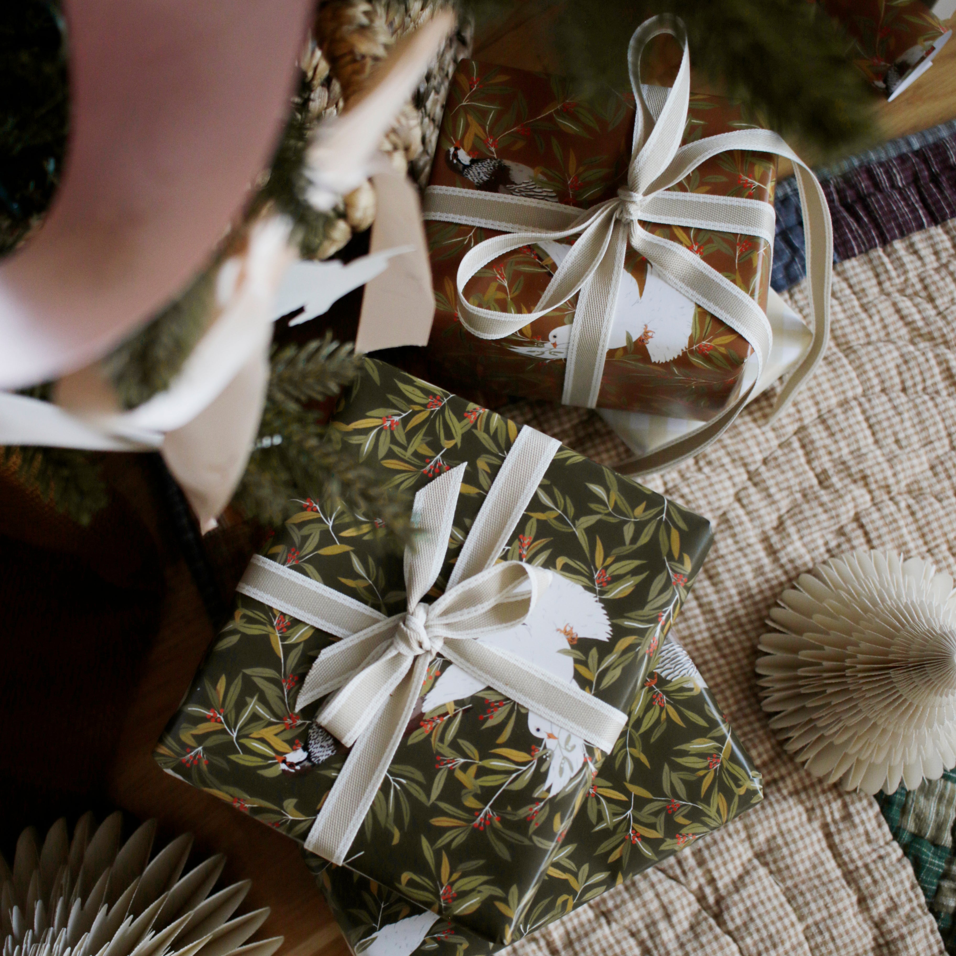 two matching designs of christmas bird pattern wrapping paper - green and umber