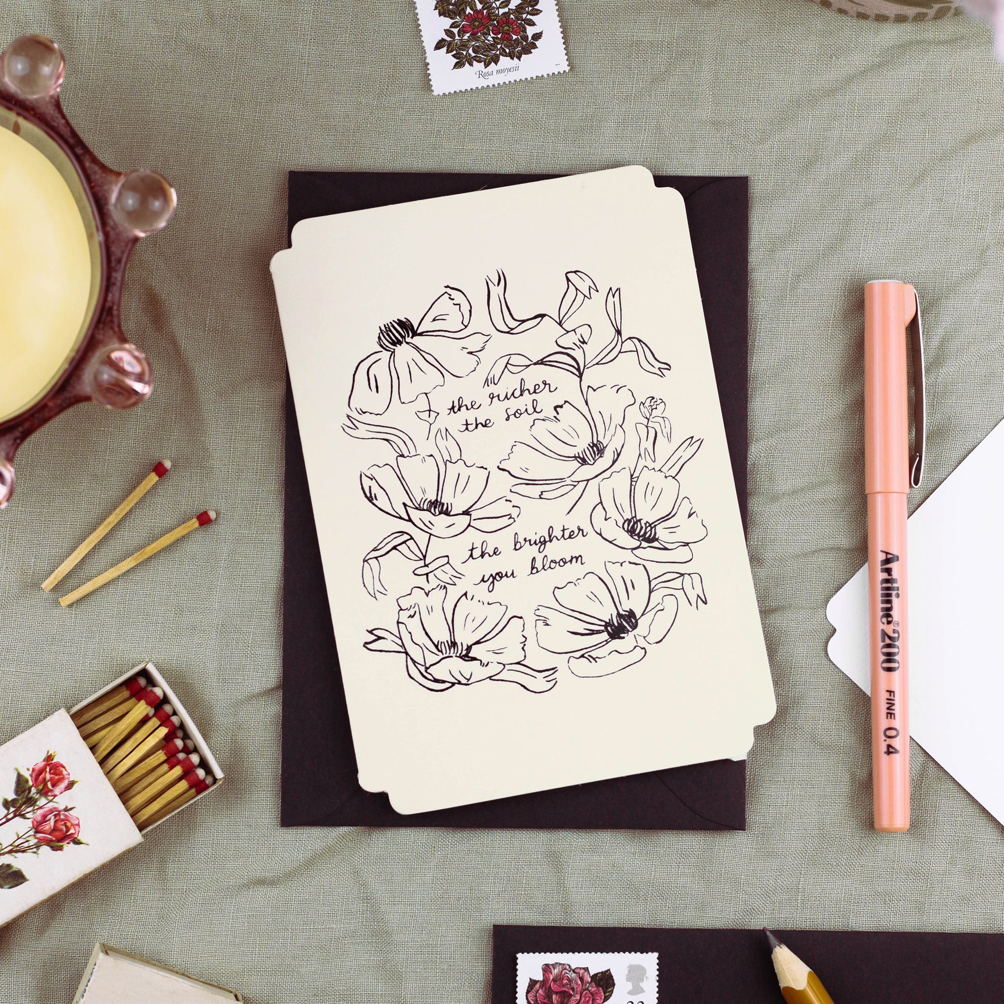 a floral encouragement card in cream, die cut in a vintage-inspired shape with embossed, linework-style florals.  - Annie Dornan Smith