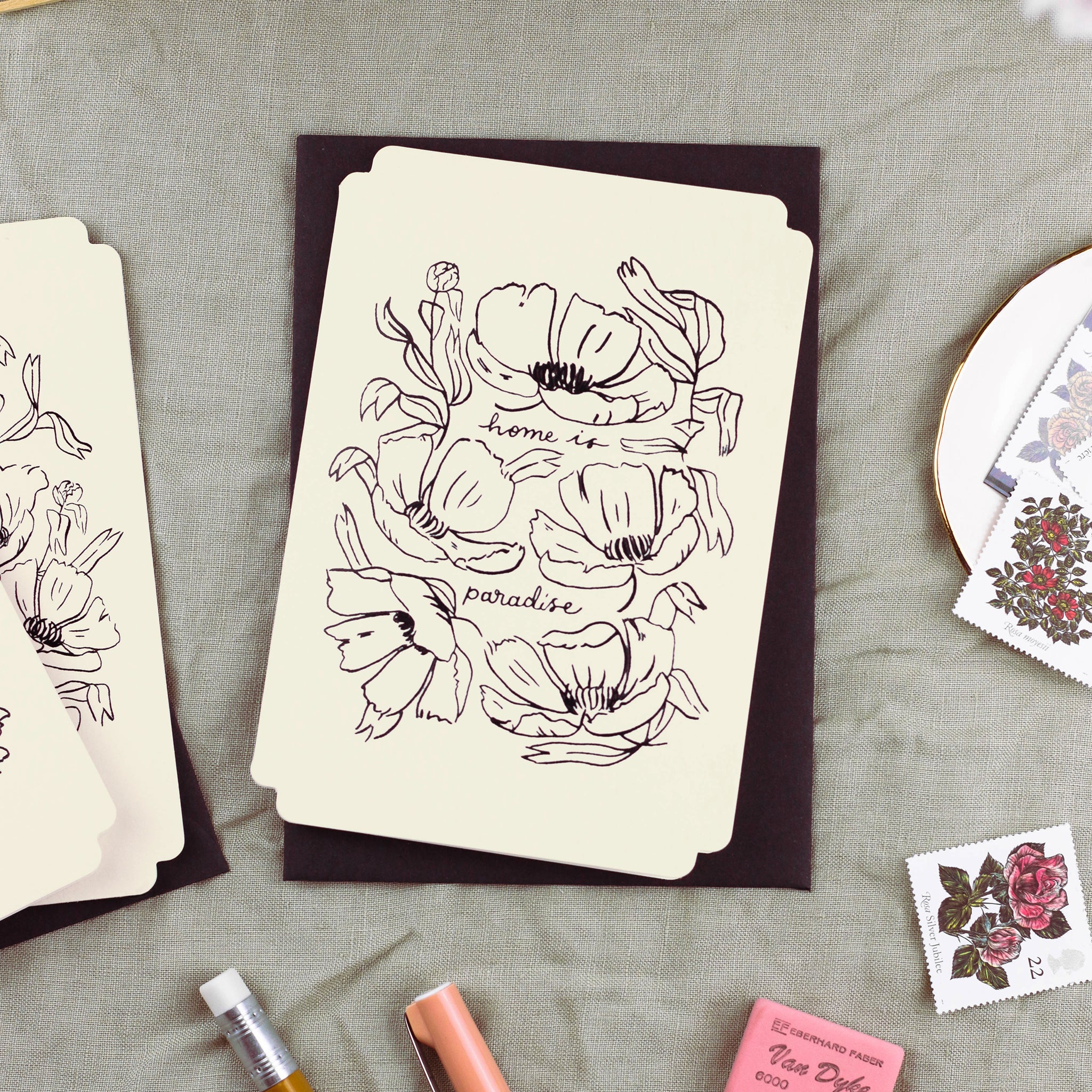 a floral card reads "home is paradise" surrounded by elegant linework flowers