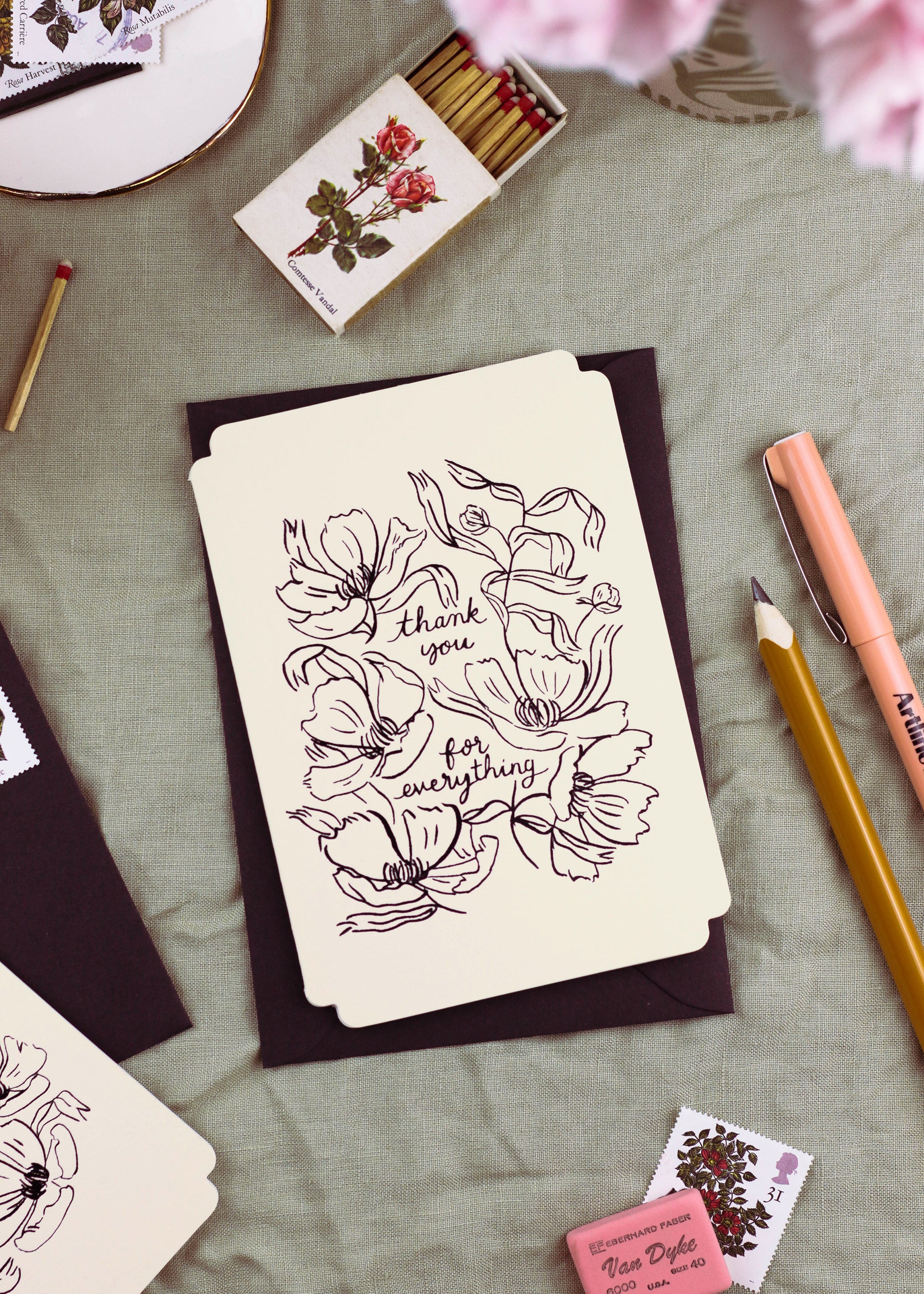 A floral-design thank you card "reads thank you for everything" in stamped black foil. It is die-cut in a vintage-inspored shape. - Annie Dornan Smith