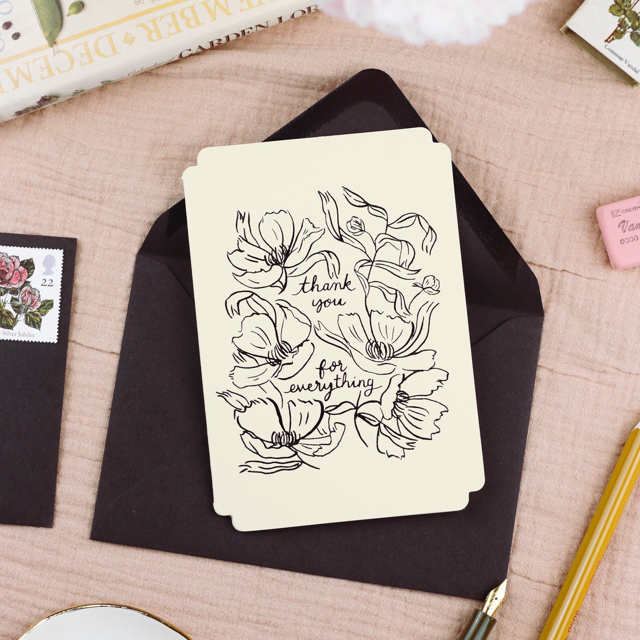 a floral, black and cream thank you card styled with a black envelope