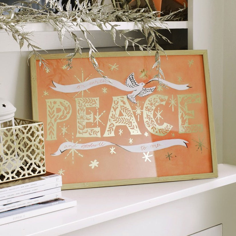 Coral Christmas Print With Gold Peace Lettering And Stars With A White Ribbon And Dove In An Oak Frame - Annie Dornan Smith