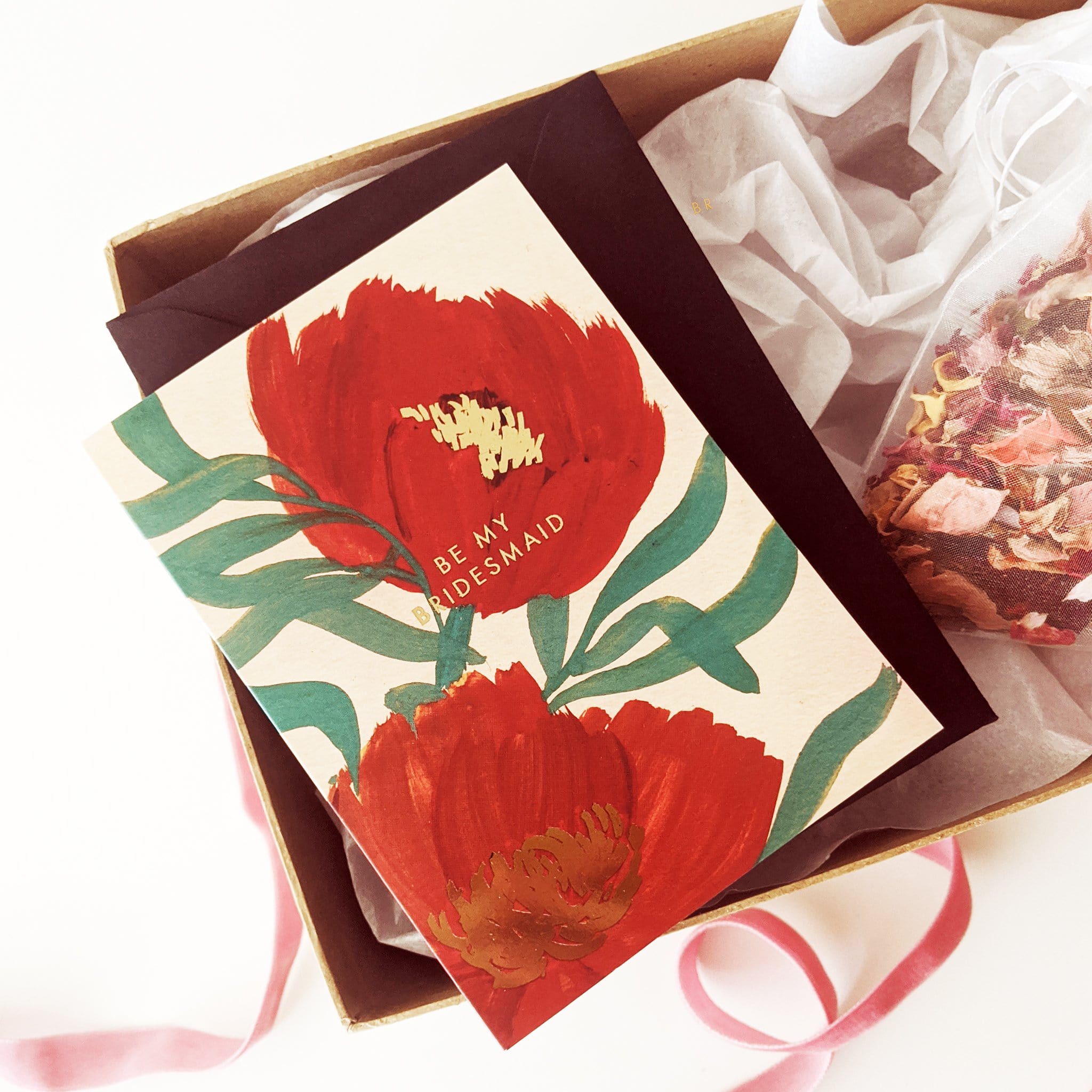 A Floral A6 Card with Red Green And Gold Flowers With Be My Bridesmaid In Gold Lettering With Black Envelope - Annie Dornan Smith