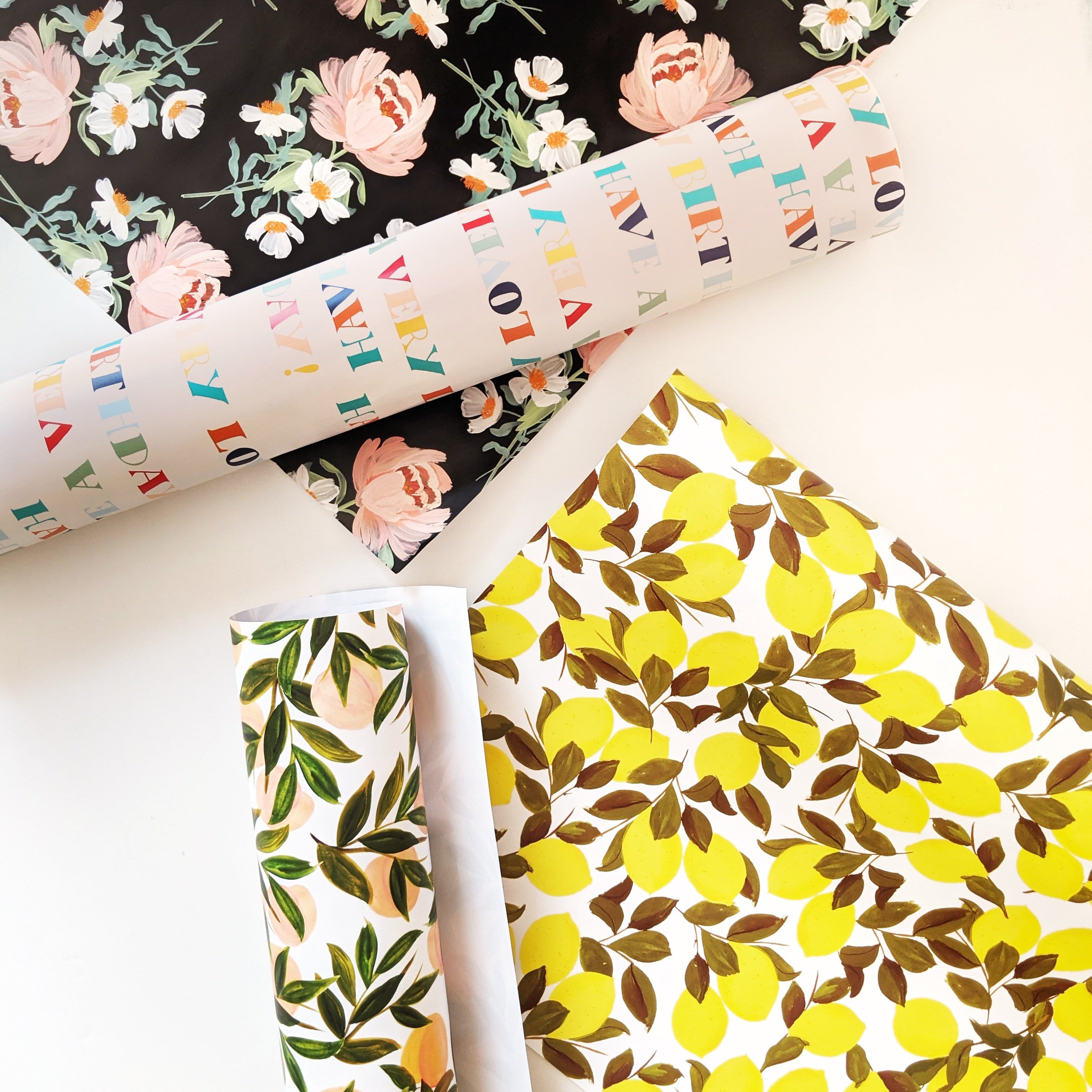 Illustrated Pink Peony Floral Wrapping Paper On A Black Background With Other Wrapping Papers - Annie Dornan Smith