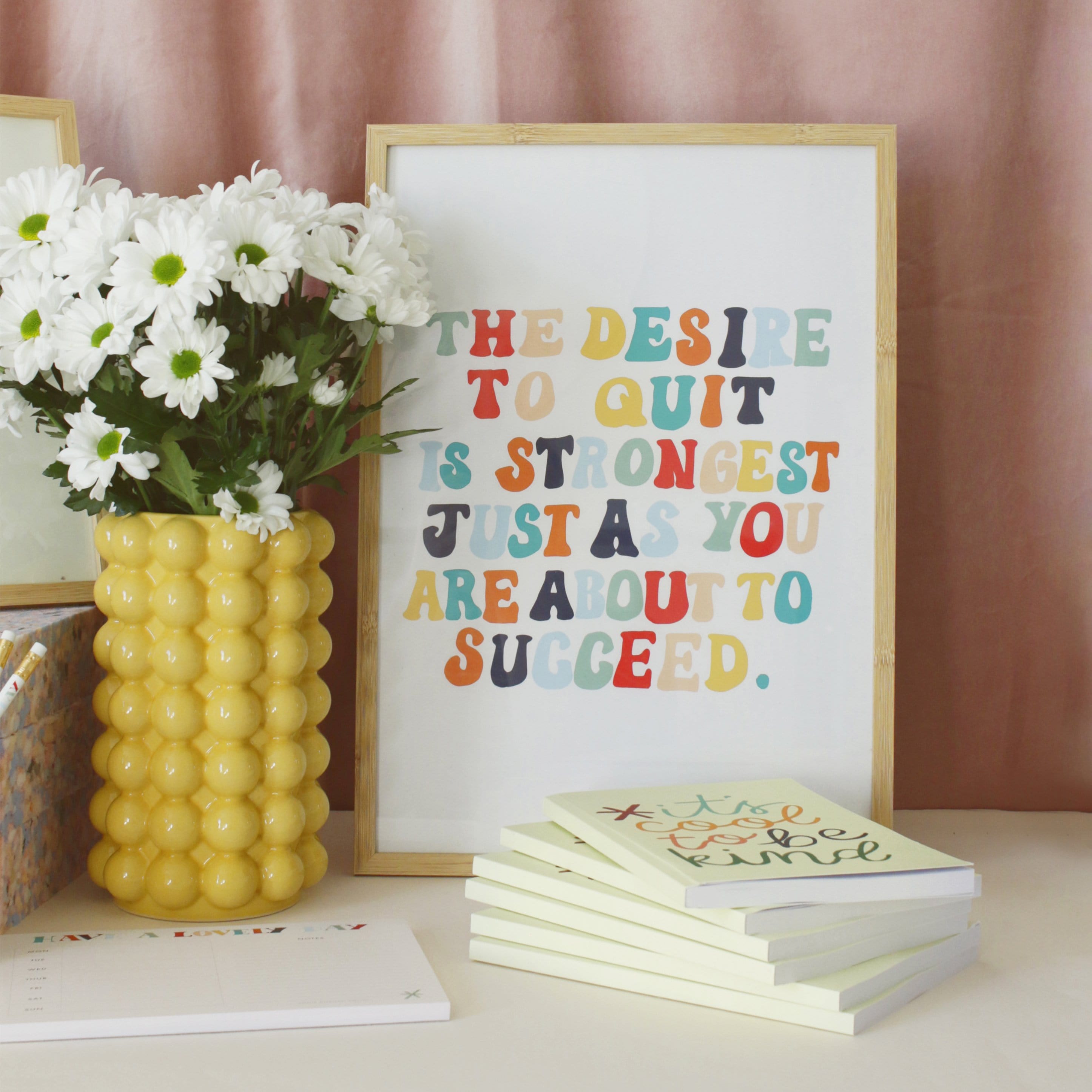 A Hand Lettered Rainbow Typography Motivational Print In A Light Oak Frame Next To A Yellow Vase - Annie Dornan Smith