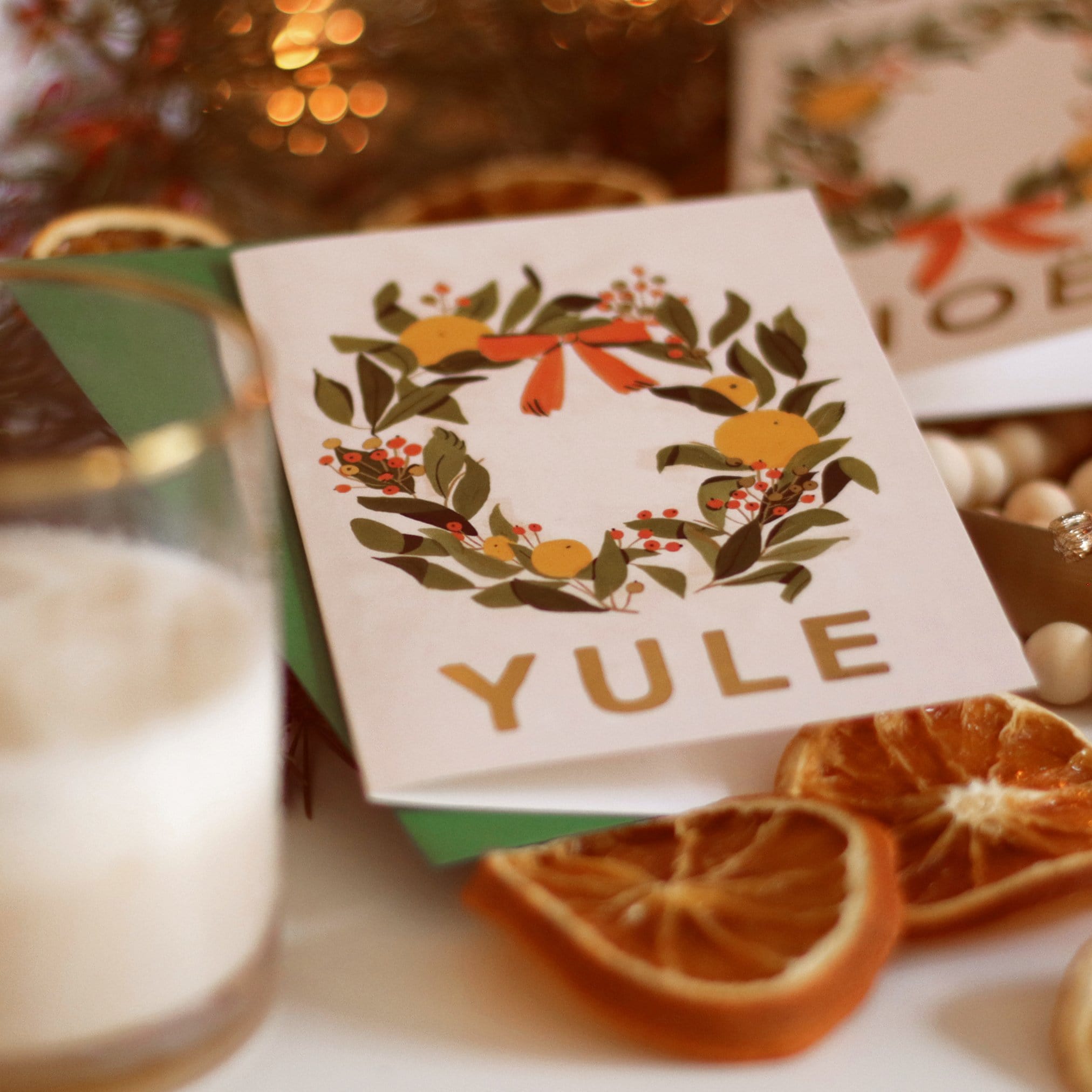 Illustrated Christmas Wreath A6 White Card With Gold Yule Lettering With Green Envelope With Christmas Decorations - Annie Dornan Smith