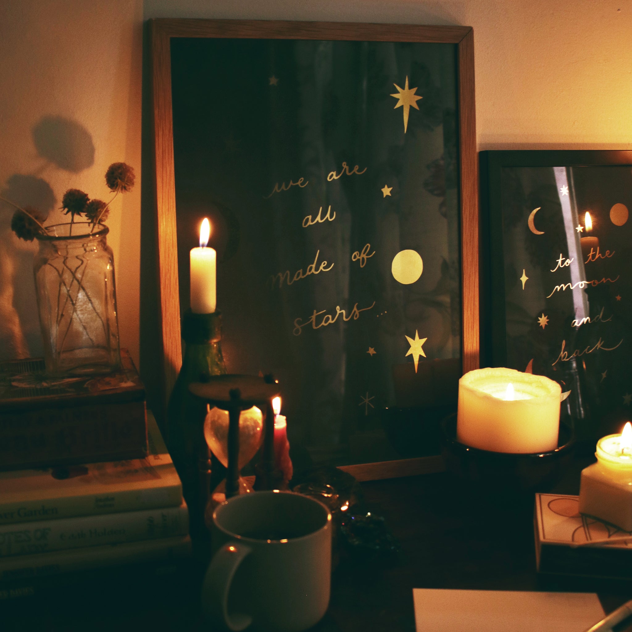 Celestial gold foil star print surrounded by candles