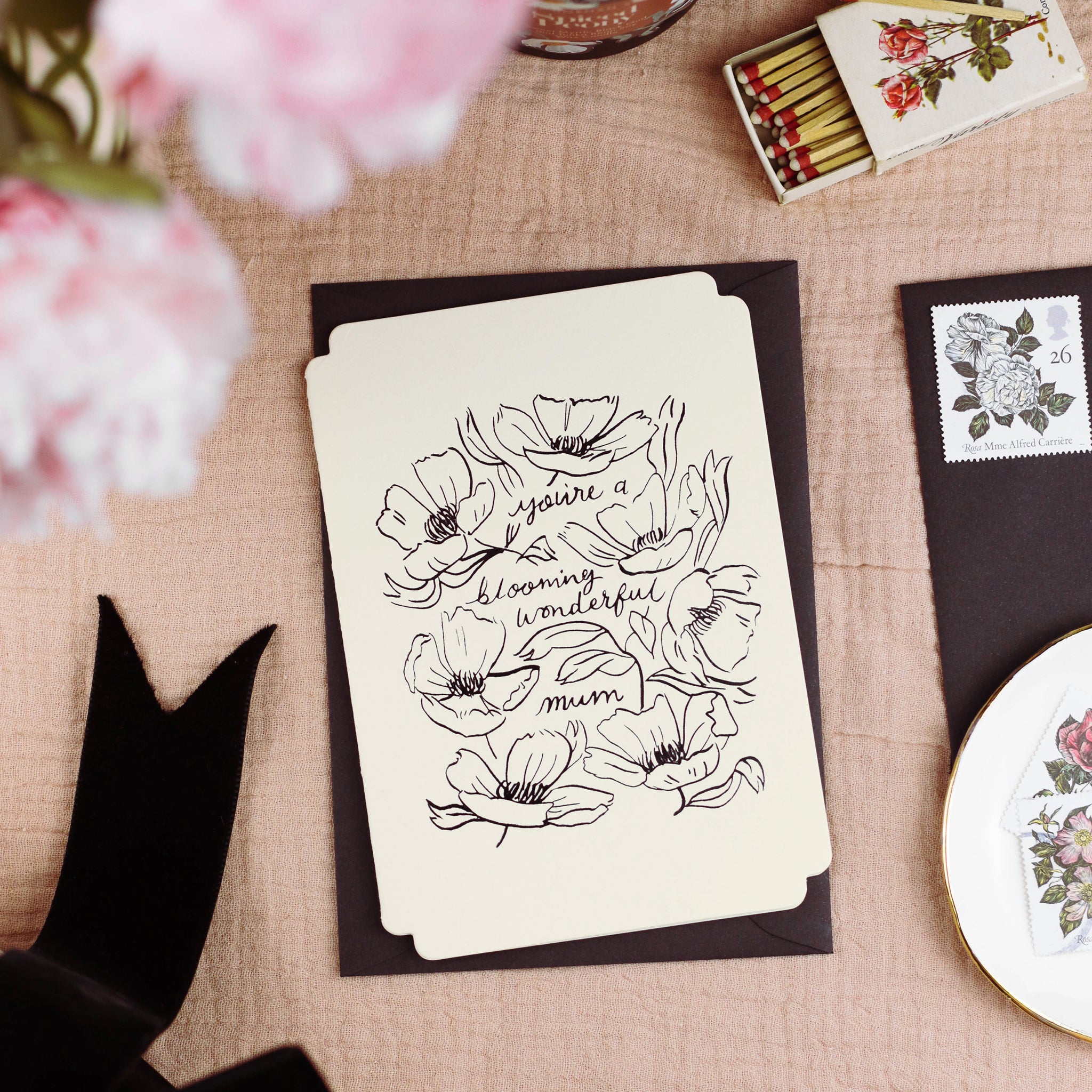 A floral mother's day card with linework-style floral design reads "you're a blooming wonderful mum" comes with a black envelope. - Annie Dornan Smith