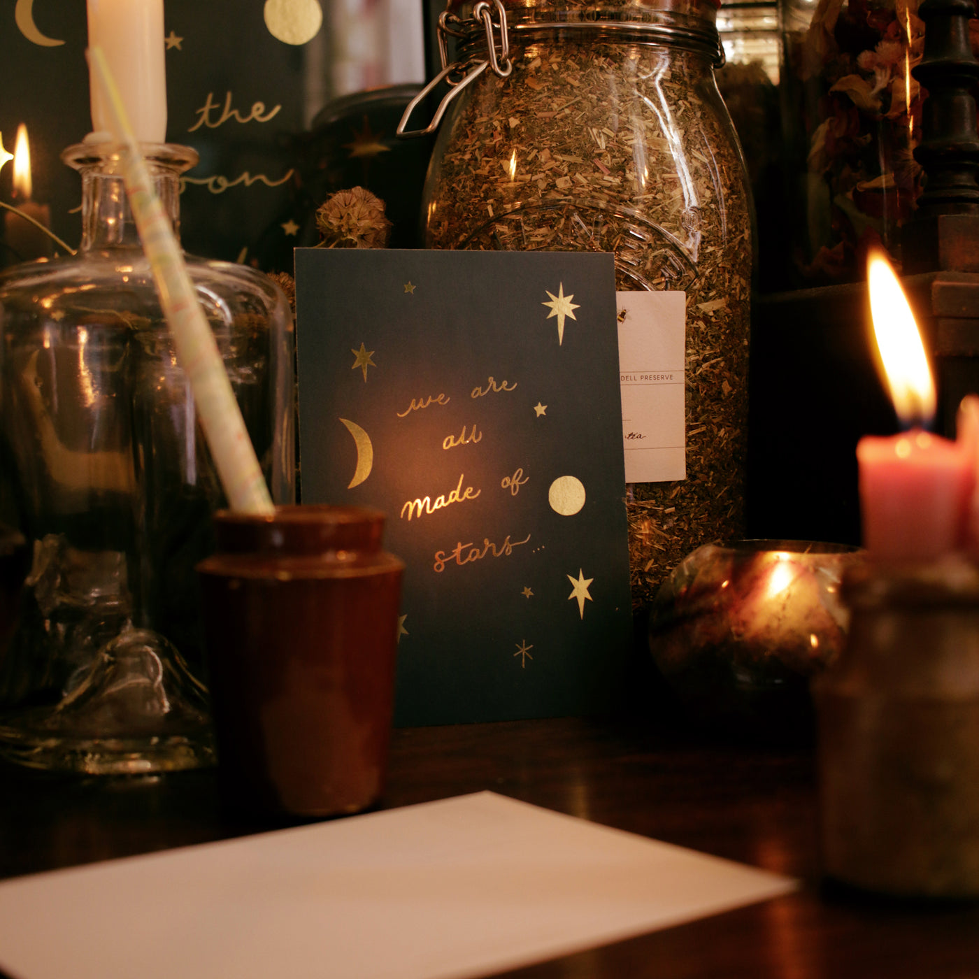 astrology postcard surrounded by apothecary bottles