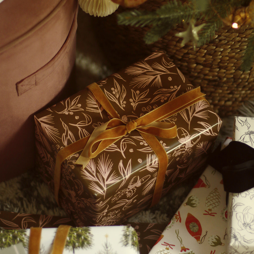 brown illustrated christmas wrapping paper with a velvet bow