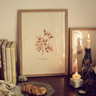 cottagecore styled corner with pink flower print, books and candles
