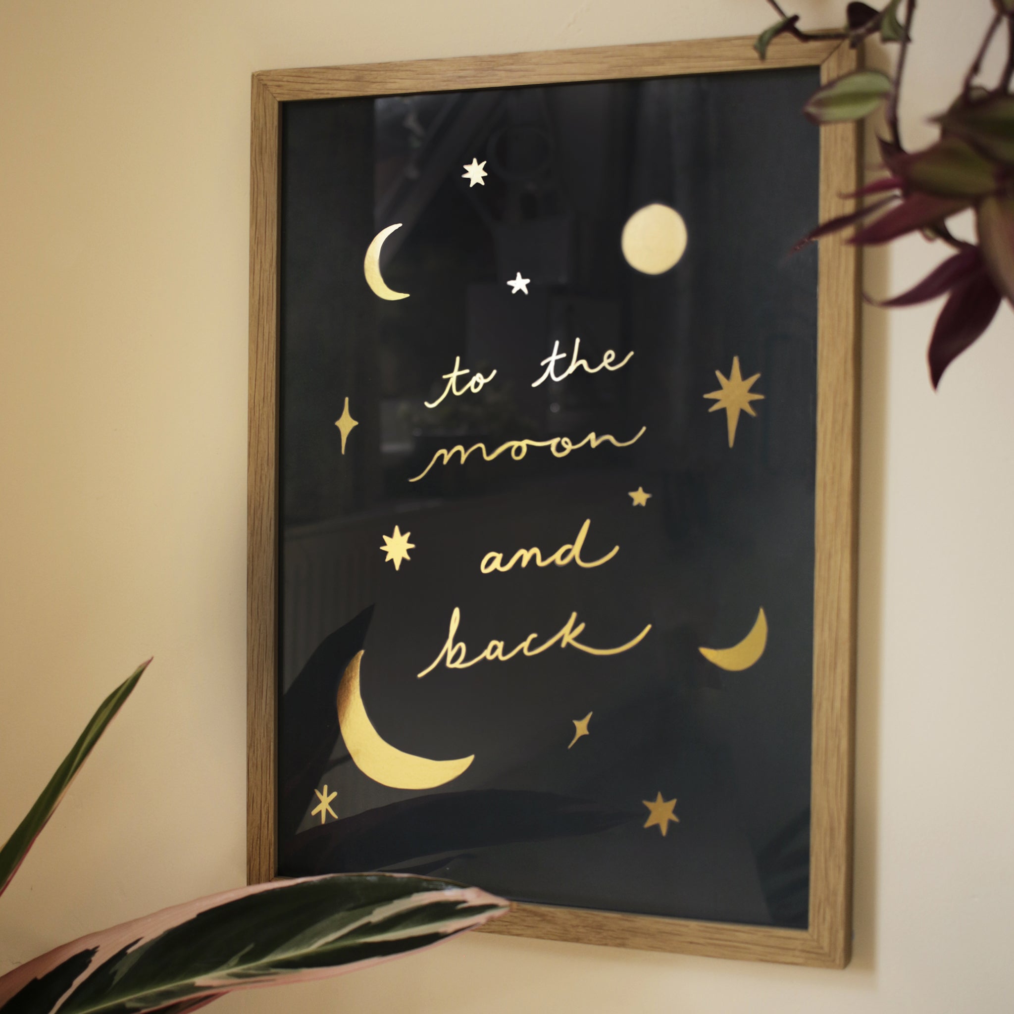 gold foil celestial print in an oak frame