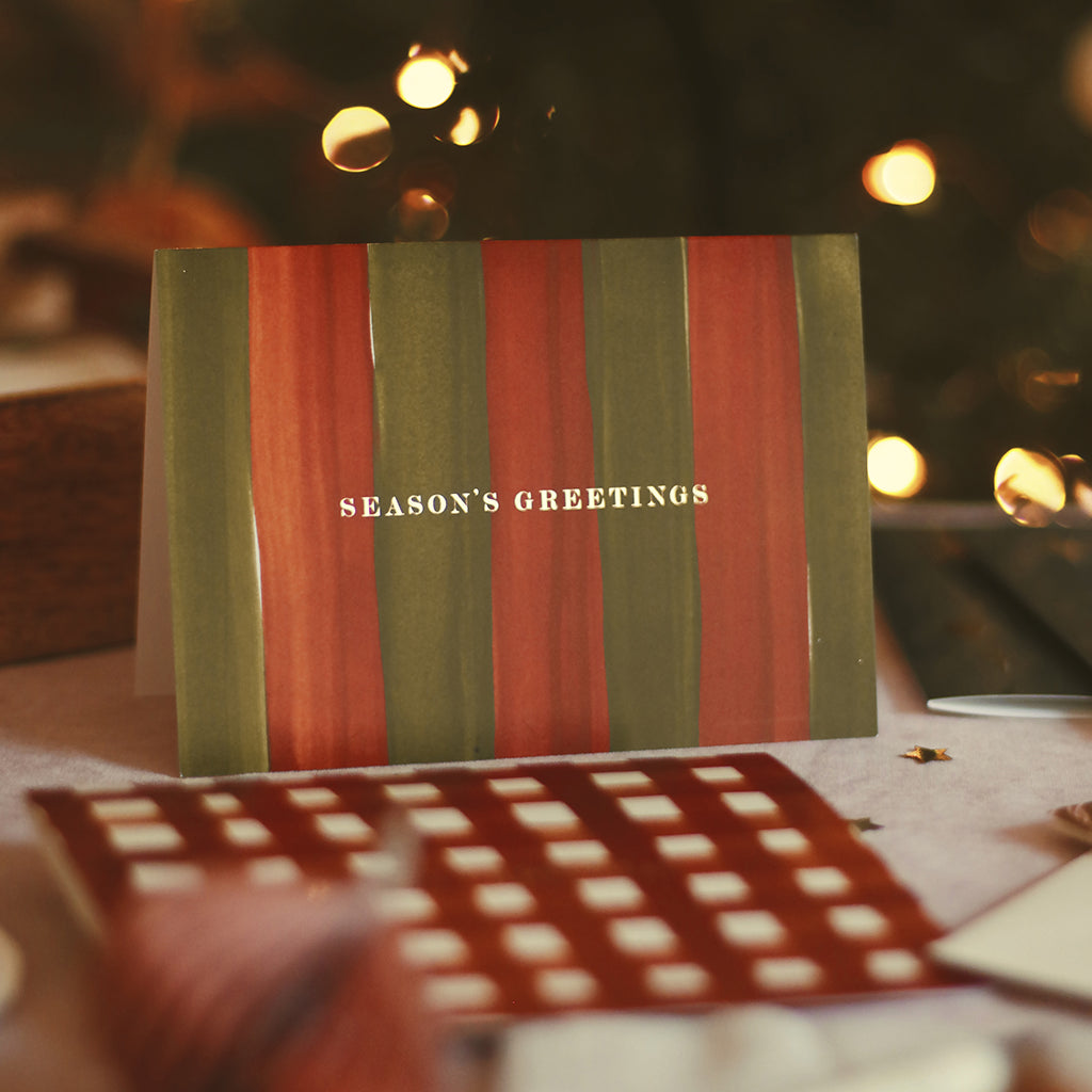 illustrated christmas cards on a table, ready to write