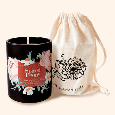A Black Candle with Spiced Peony Label  with Floral illustrations With Linen Drawstring Bag - Annie Dornan Smith