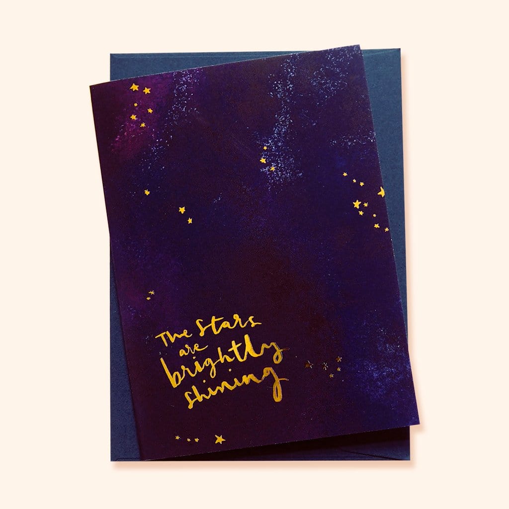 An Inky Galaxy A6 Card With The Stars Are Brightly Shining in Gold With A Blue Envelope - Annie Dornan Smith