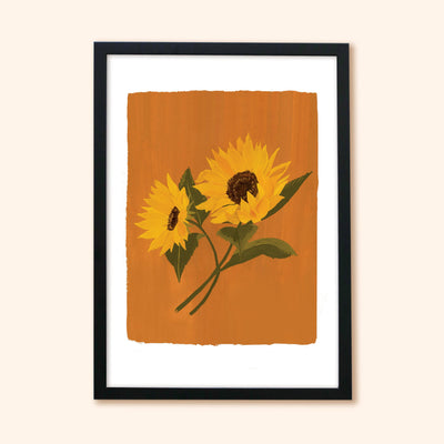A Botanical Print Of Two Sunflowers On A Burnt Orange Background In A Black Frame - Annie Dornan Smith