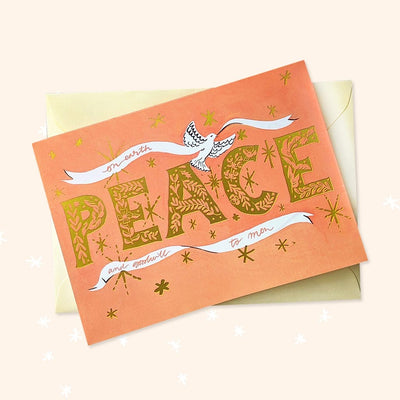Coral Christmas Card With Gold Peace Lettering And Stars With A White Ribbon And Dove With A Gold Envelope - Annie Dornan Smith