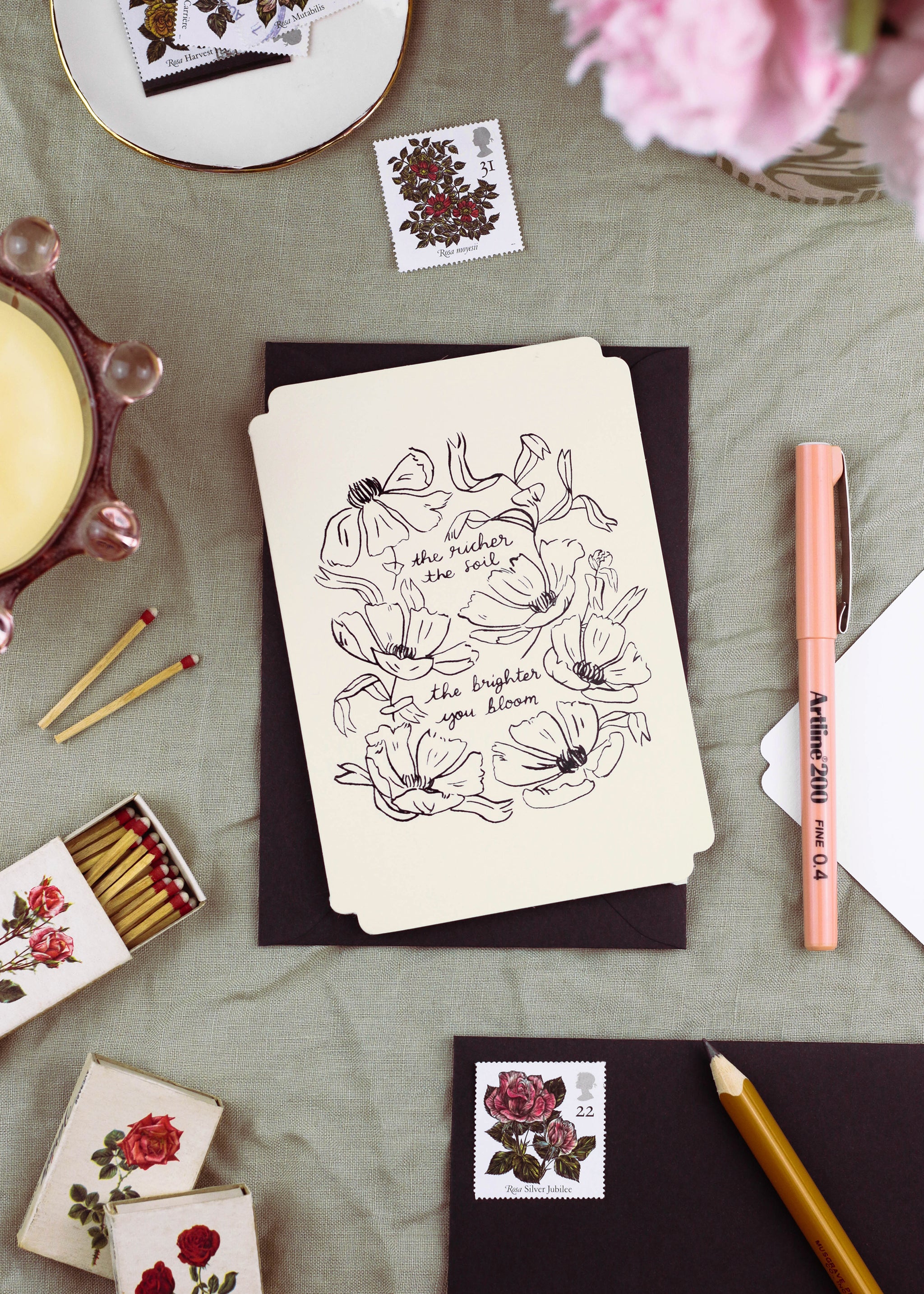 a floral encouragement card in cream, die cut in a vintage-inspired shape with embossed, linework-style florals.  - Annie Dornan Smith