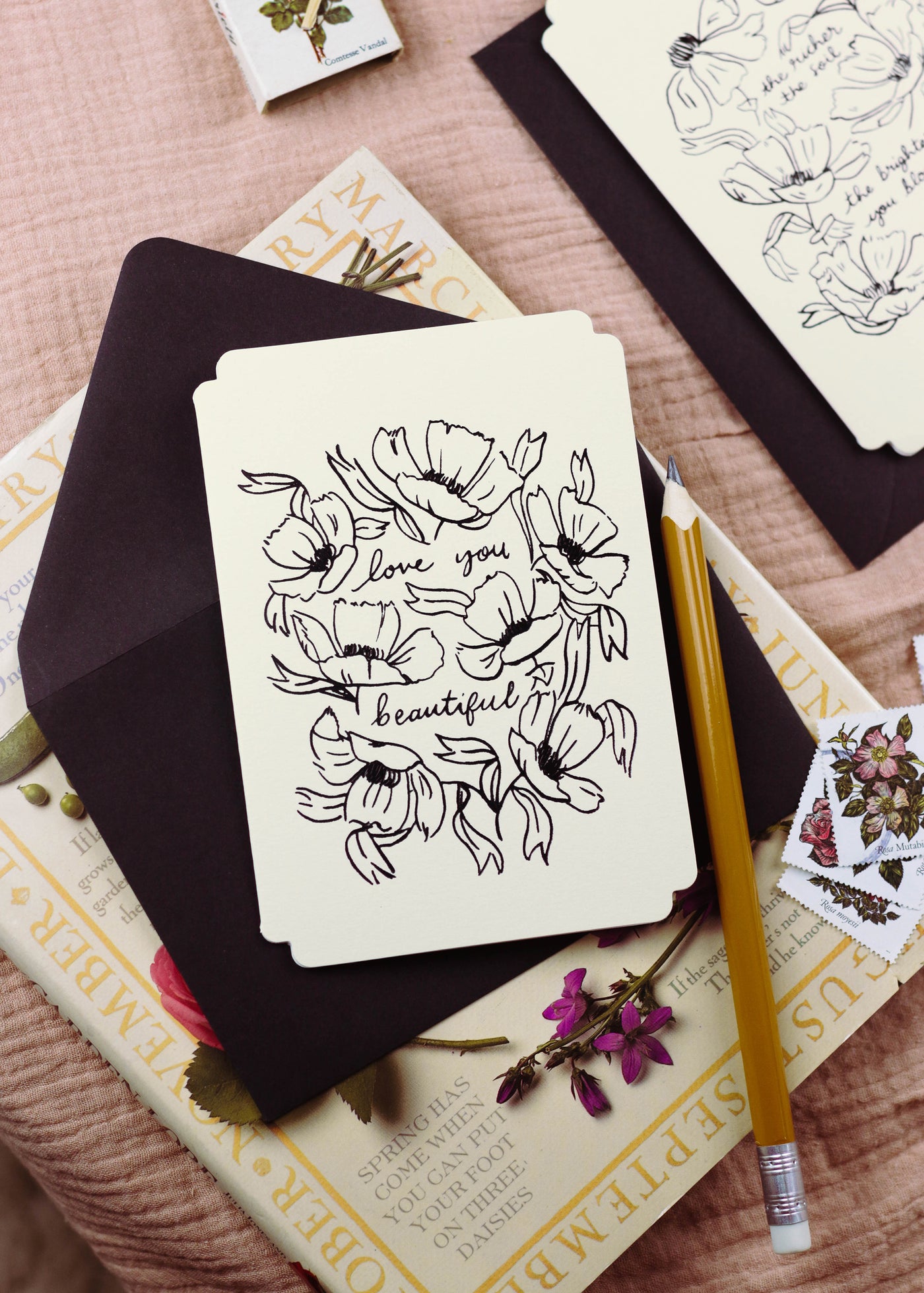 A cream, die-cut valentines card with black, foiled, linework-style flower illustrations - Annie Dornan Smith