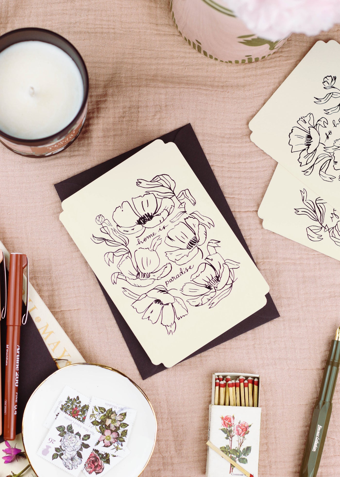 a floral card reads "home is paradise" surrounded by elegant linework flowers