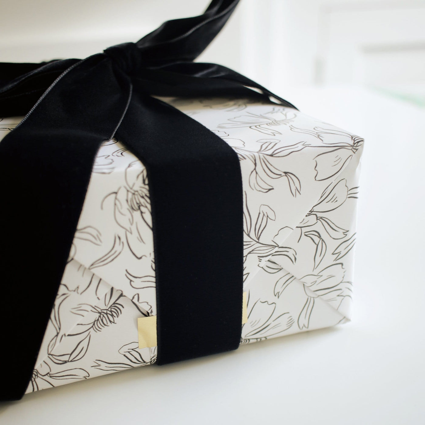 Gift Wrapped In Floral Line Art Paper With Black Velvet Bow - Annie Dornan Smith