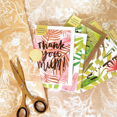 Bundle Of Six Plant Based Greeting Cards Laid on Floral Tissue Paper With Gold Scissors - Annie Dornan Smith