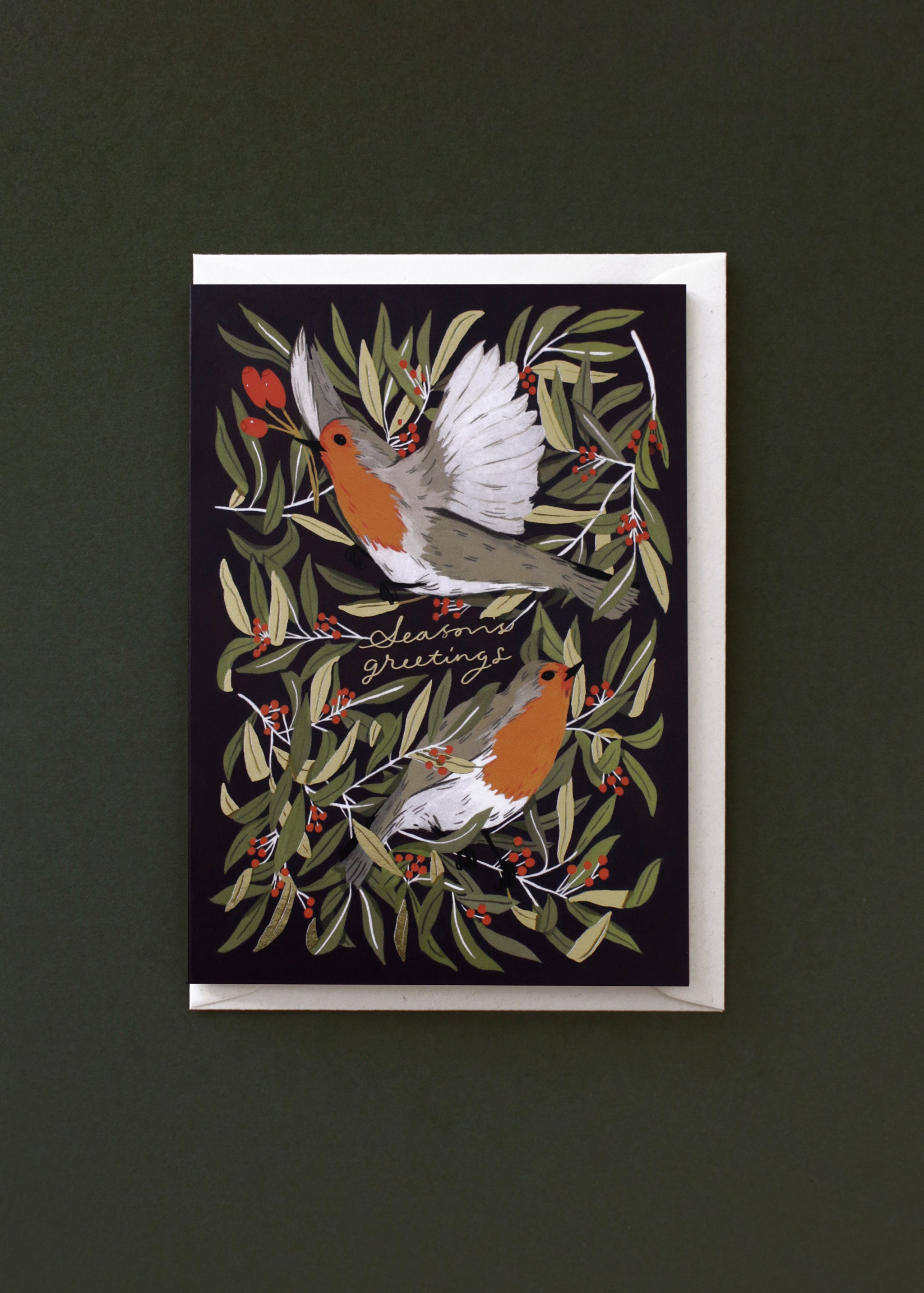  A lovely, navy blue Christmas card featuring two illustrated robins, finished with gold foil details. It comes paired with a recycled cream envelope.