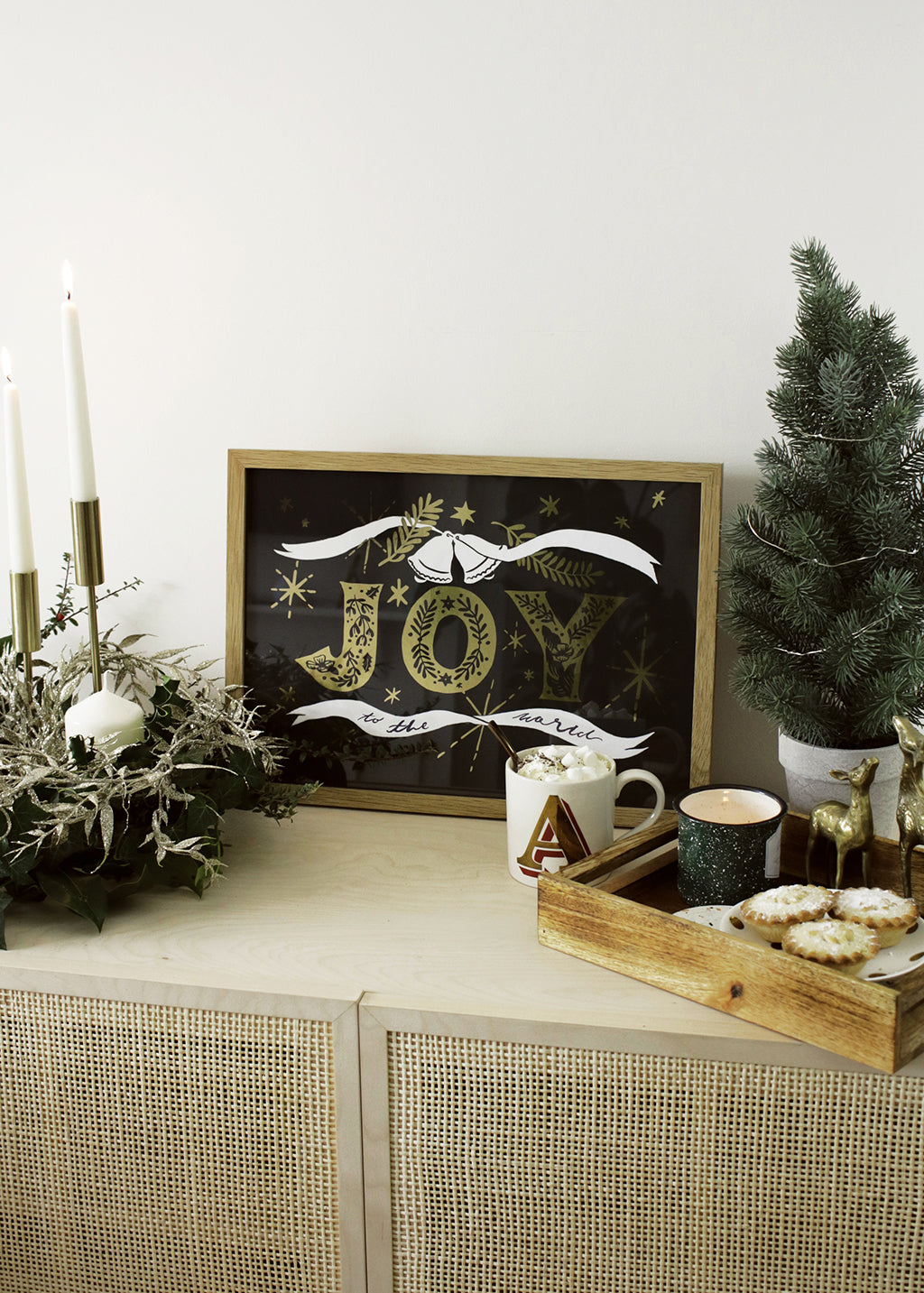 Navy Christmas Print With Gold Joy Lettering And Stars In An Oak Frame With Mug Of A Hot Chocolate - Annie Dornan Smith
