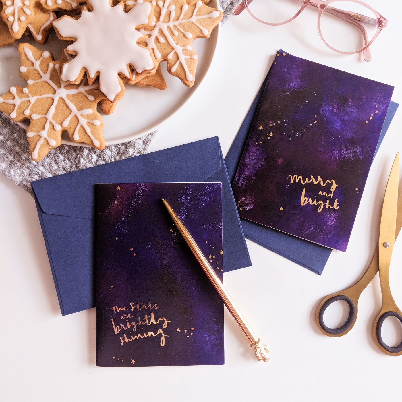 Purple Galaxy Christmas Card With The Words Merry An Bright In Gold With A Deep Navy Envelope Coupled With Another Galaxy Christmas Card - Annie Dornan Smith