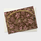 a luxue patterned christmas card with gold foil lettering and frame illustration