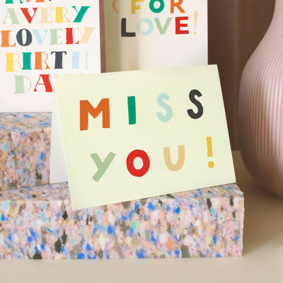 A Hand Lettered Rainbow Typography Card Which Reads Miss You On A Desk - Annie Dornan Smith