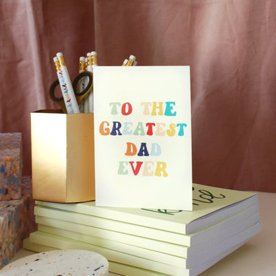A Hand Lettered Rainbow Typography Father's Day Card Which Reads To the Greatest Dad Ever Next To A Pencil Pot - Annie Dornan Smith