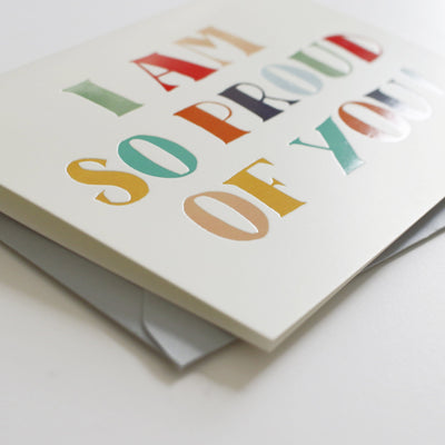 A Hand Lettered Rainbow Typography Card Which Reads I Am So Proud Of You With Pale Grey Envelope - Annie Dornan Smith