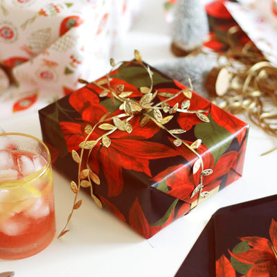 Gift Wrapped In Red Poinsettias Christmas Wrapping Paper With A Gold Leaf Ribbon  - Annie Dornan Smith