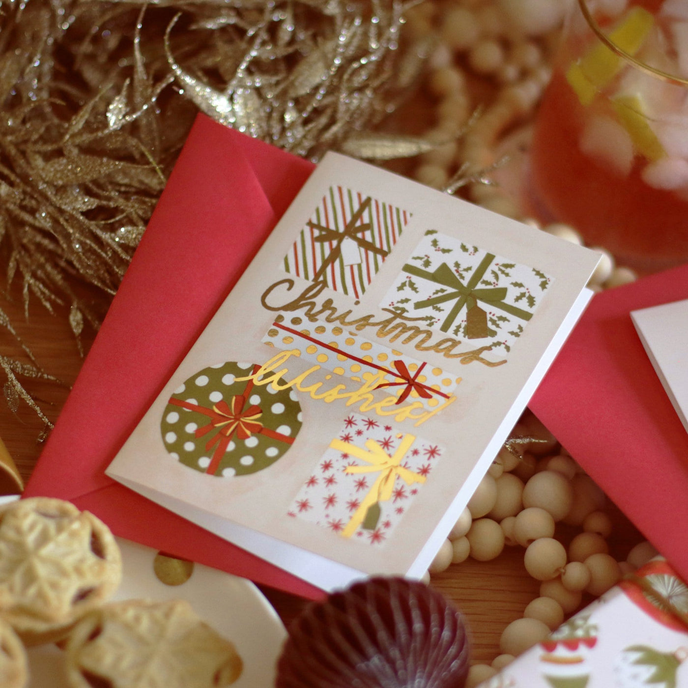 Illustrated Christmas Present A6 Card With Christmas Wishes In Gold Lettering With Red Envelope - Annie Dornan Smith