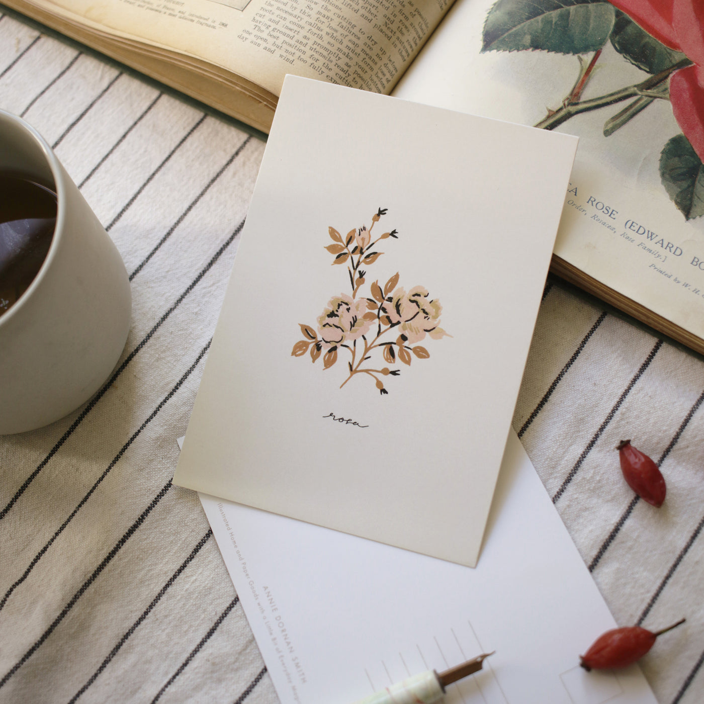 writing a rose flower postcard on the kitchen table