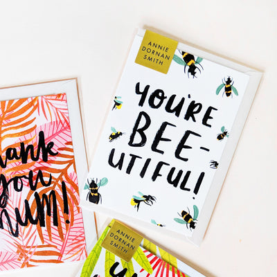 Hand Lettered Greeting Card Reading You're Beeutiful With Illustrated Bees With An Oyster Envelope - Annie Dornan Smith  Edit alt text