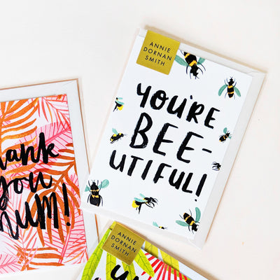 Hand Lettered Greeting Card Reading You're Beeutiful With Illustrated Bees With An Oyster Envelope - Annie Dornan Smith  Edit alt text