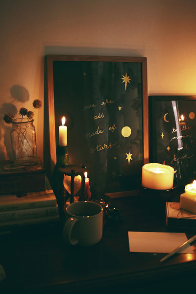 Celestial gold foil star print surrounded by candles