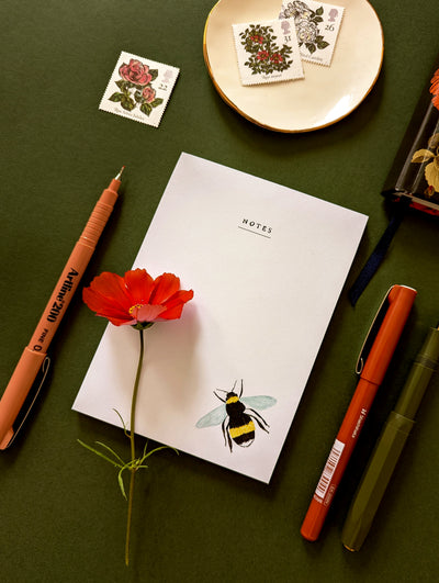 note pad with a illustrated bee design 