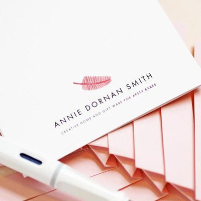 The Back Of A Greeting Card With Annie Dornan Smith And A Pink Feather - Annie Dornan Smith
