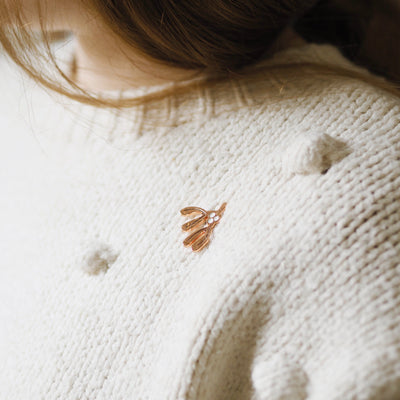 Rose Gold Enamel Mistletoe Shaped Pin On A Cream Jumper - Annie Dornan Smith