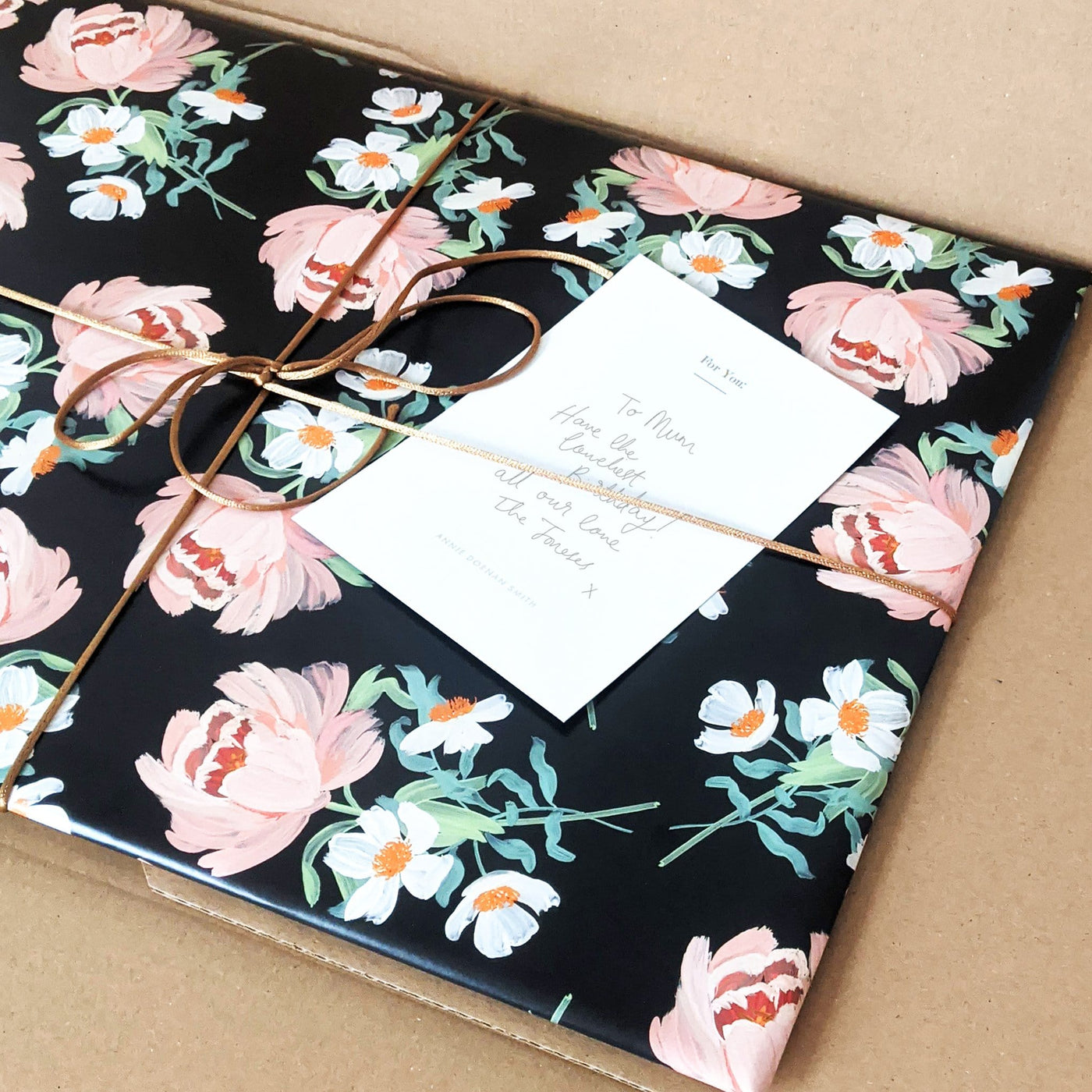 Wrapped Present In Black Floral Paper With Brown String - Annie Dornan Smith