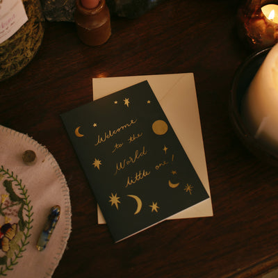 welcome to the world gold foil card with a cream envelope