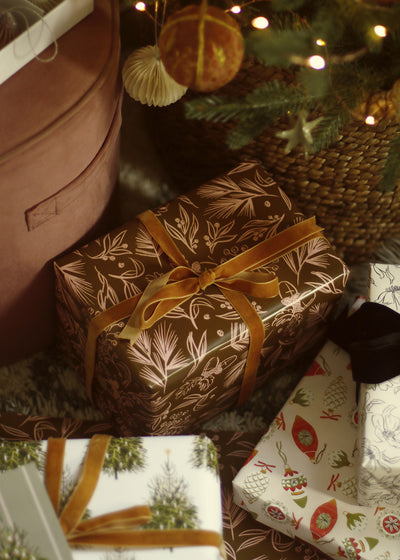 brown illustrated christmas wrapping paper with a velvet bow