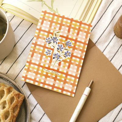 writing in a gingham and floral birthday card
