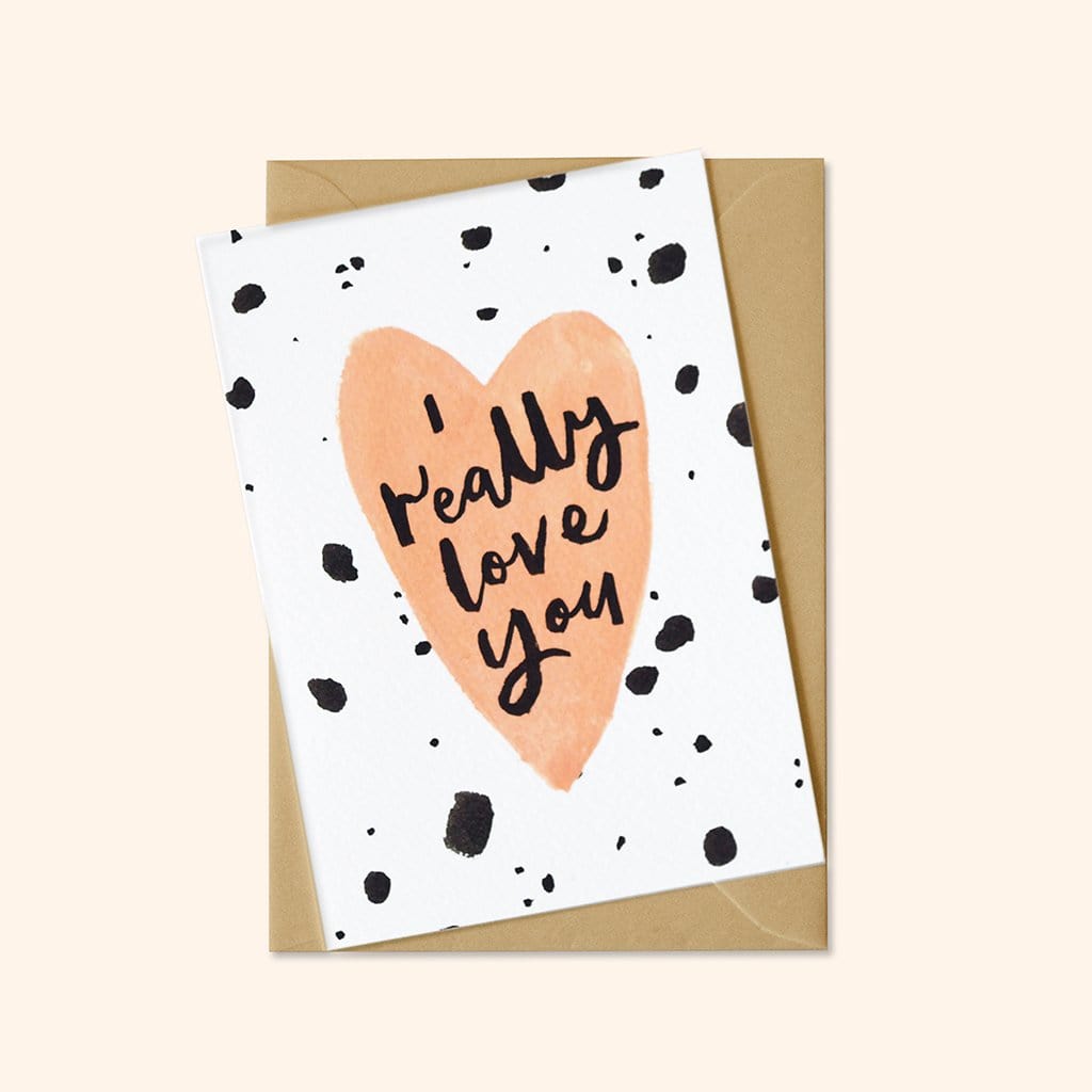 A Hand Lettered Card Which Reads I Really Love You On A Peach Heart  With Black Paint Dots With A Kraft Envelope  - Annie Dornan Smith