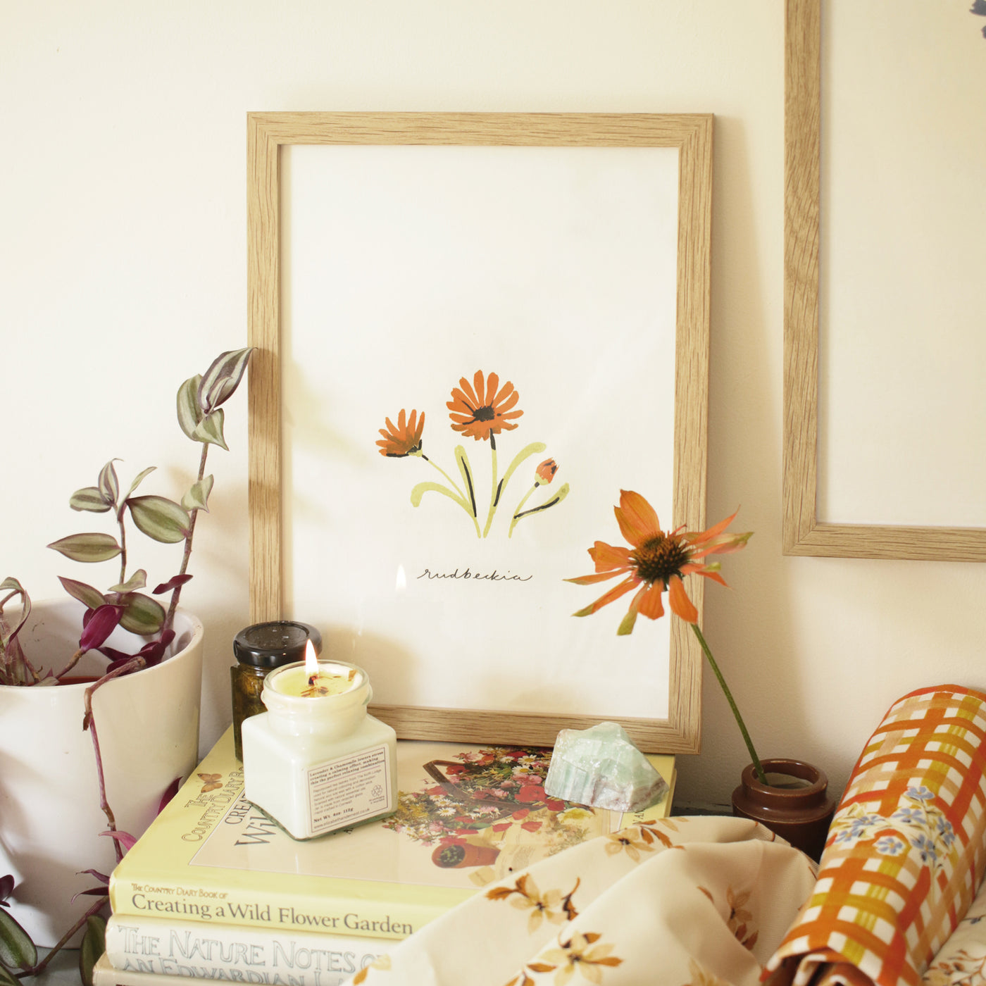 orange daisy print in an oak frame, styled in a cottagecore style