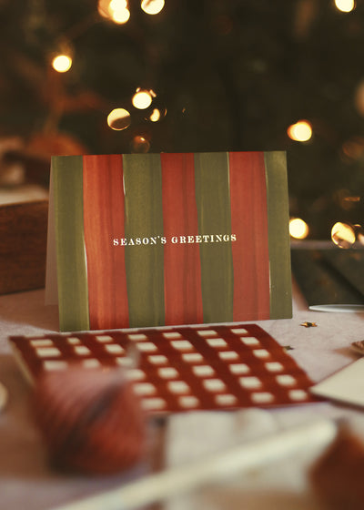 illustrated christmas cards on a table, ready to write